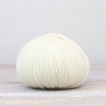 A single ball of The Fiber Co. &Make Aran in color Betty White