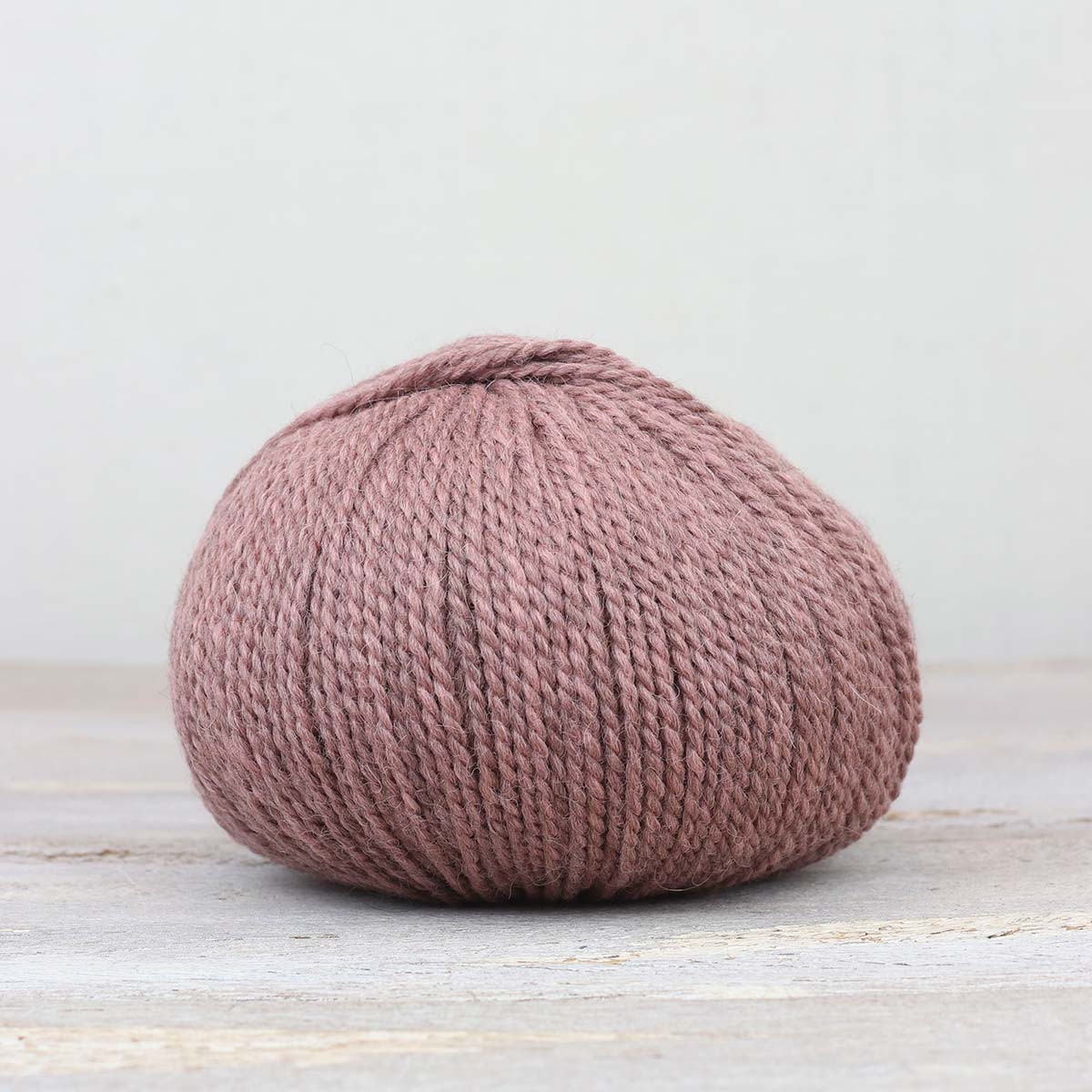 A single ball of The Fiber Co. &Make Aran in color Blush Blush