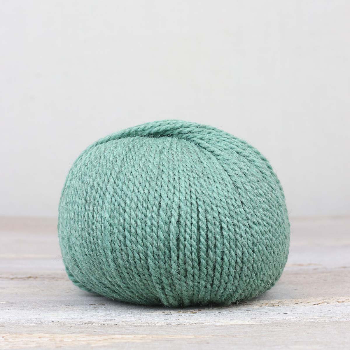 A single ball of The Fiber Co. &Make Aran in color Cowabunga