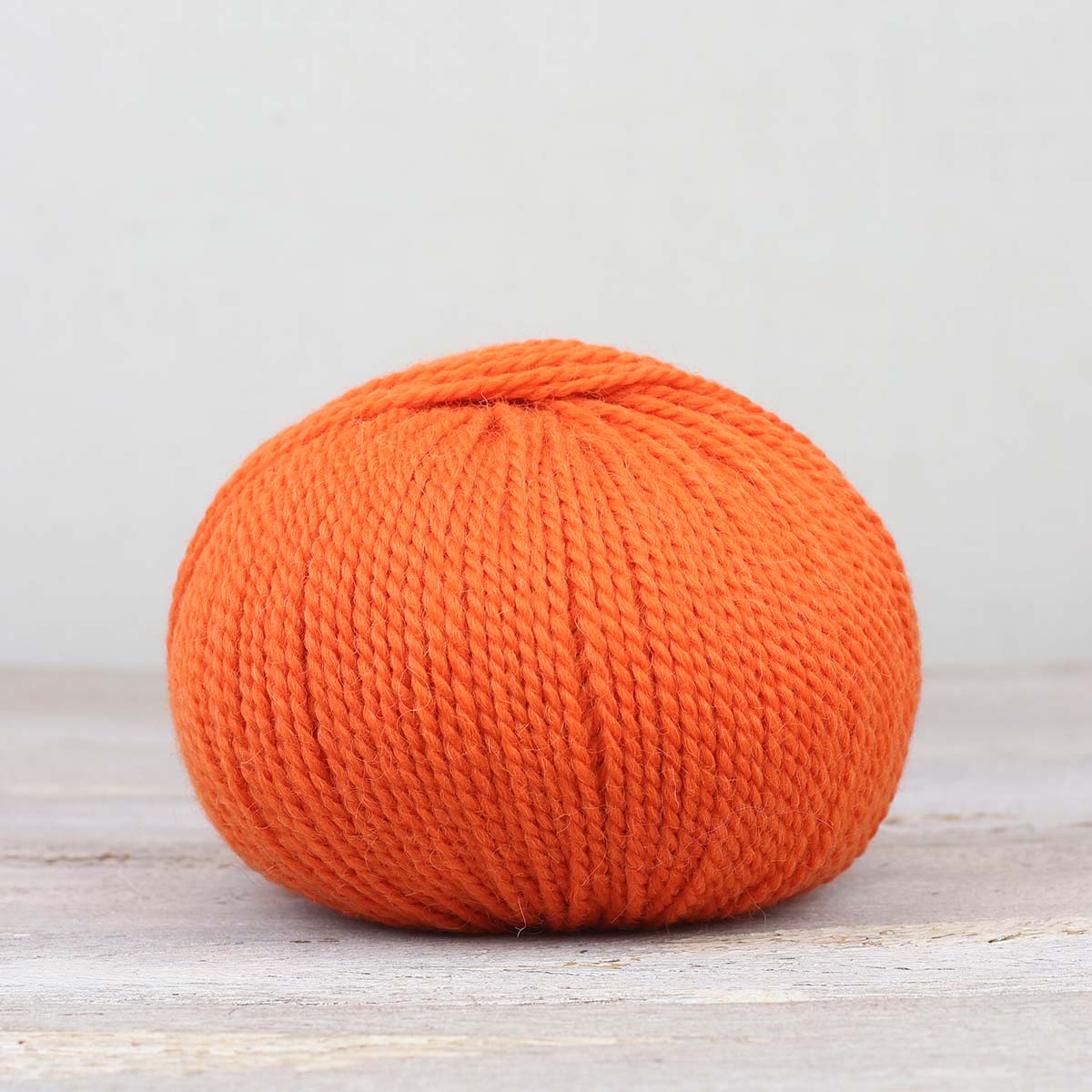 A single ball of The Fiber Co. &Make Aran in color Lit