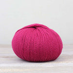 A single ball of The Fiber Co. &Make Aran in color Mille Pink