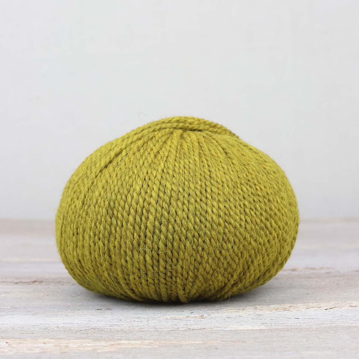 A single ball of The Fiber Co. &Make Aran in color Mon Ami