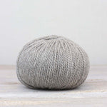 A single ball of The Fiber Co. &Make Aran in color Silver Screen