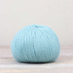 A single ball of The Fiber Co. &Make Aran in color Skylar