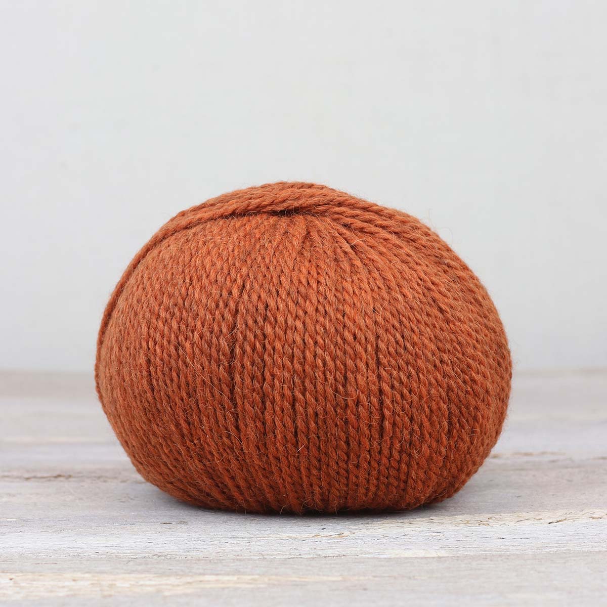 A single ball of The Fiber Co. &Make Aran in color Spill The Tea