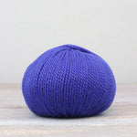 A single ball of The Fiber Co. &Make Aran in color Wink